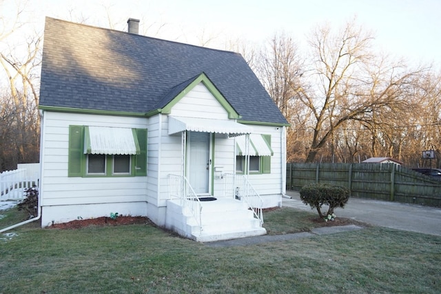 bungalow-style home with a front lawn