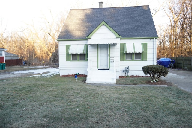 bungalow-style house featuring a front yard