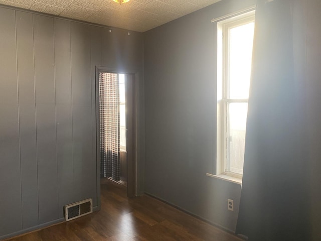 spare room with dark hardwood / wood-style flooring