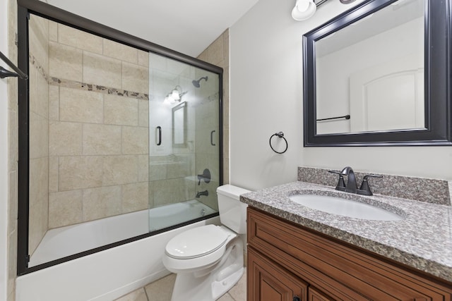 full bathroom featuring tile patterned floors, vanity, toilet, and combined bath / shower with glass door