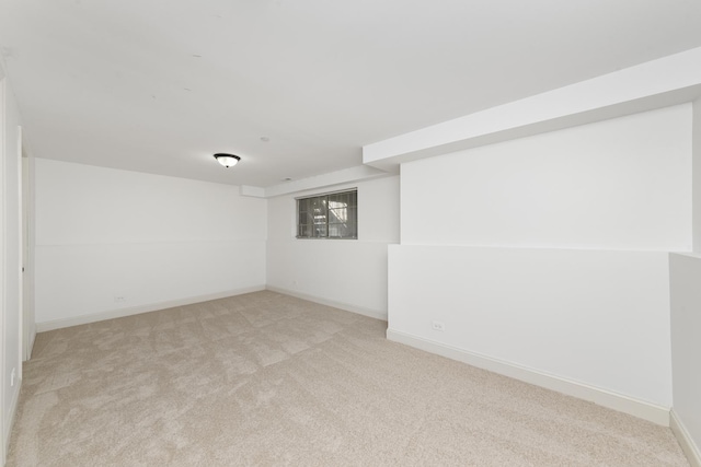 basement featuring light colored carpet