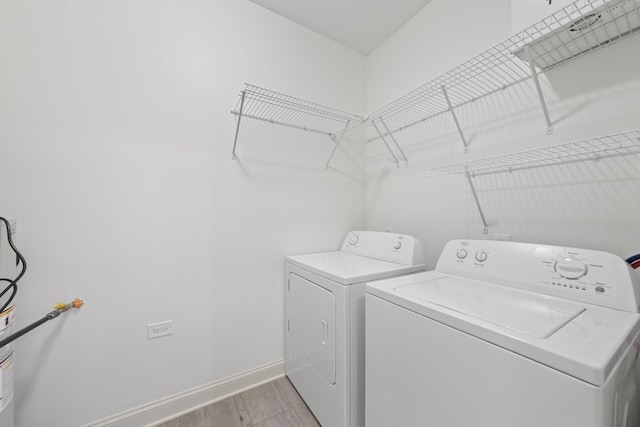 washroom featuring washer and clothes dryer and light wood-type flooring