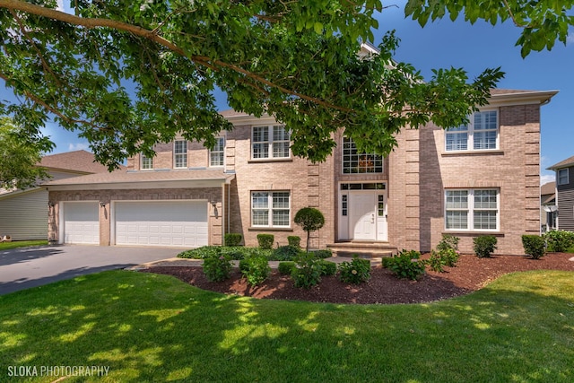 view of front of house featuring a garage and a front yard