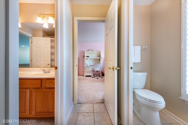 bathroom featuring vanity, toilet, and tile patterned flooring