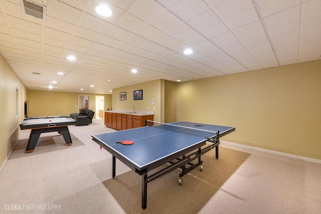 rec room featuring light colored carpet and wet bar