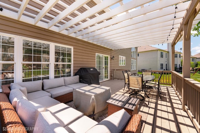 view of patio featuring an outdoor living space, a wooden deck, area for grilling, and a pergola