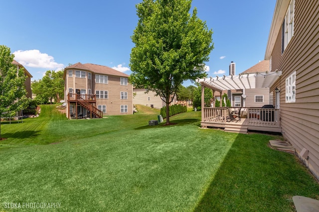 view of yard with a wooden deck and a pergola