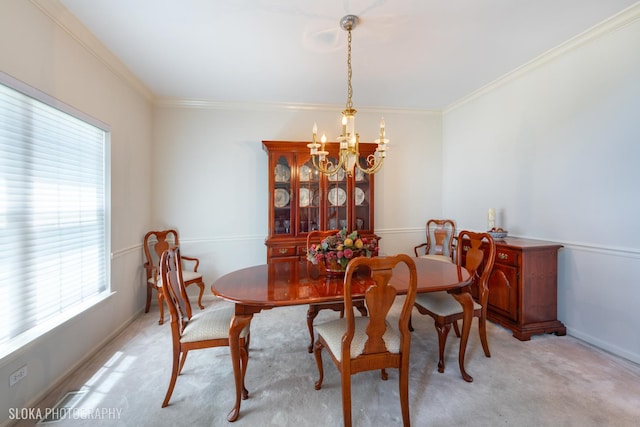 dining room with an inviting chandelier, light colored carpet, plenty of natural light, and crown molding