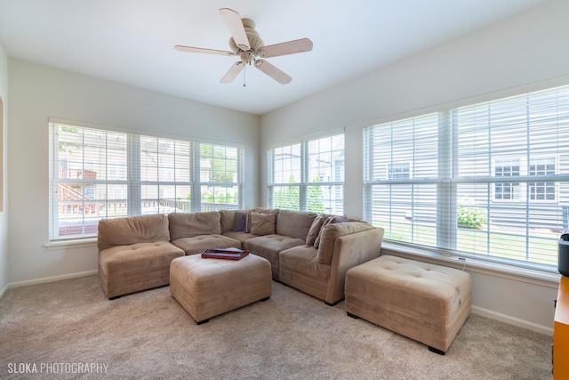 carpeted living room with ceiling fan