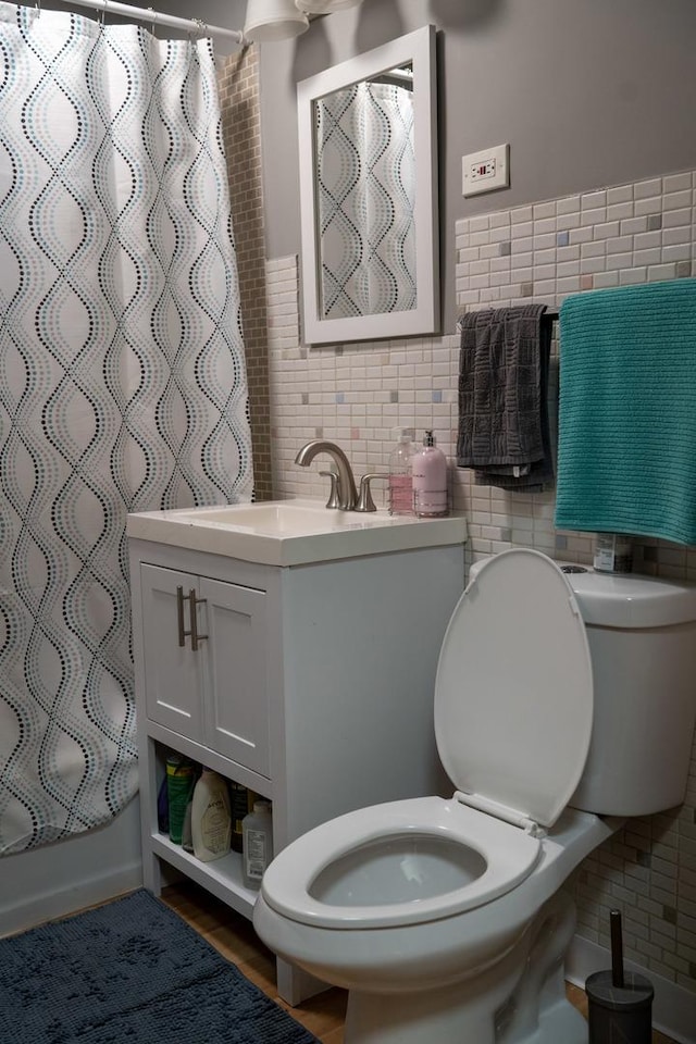 full bathroom featuring toilet, tile walls, vanity, shower / bath combination with curtain, and backsplash