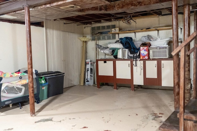 basement featuring an AC wall unit