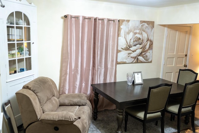 dining space with crown molding