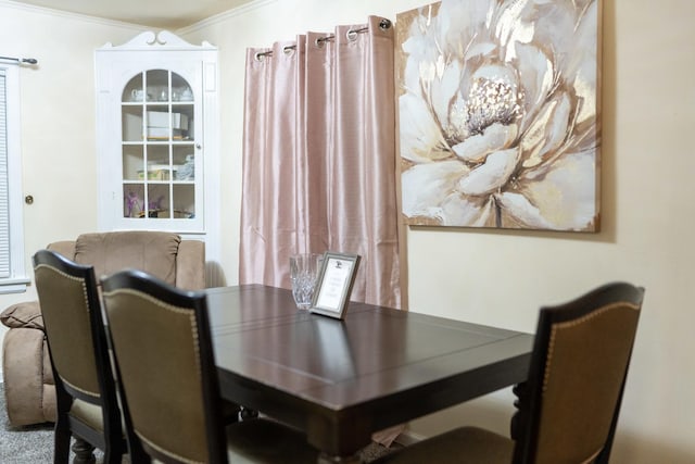 dining space with crown molding