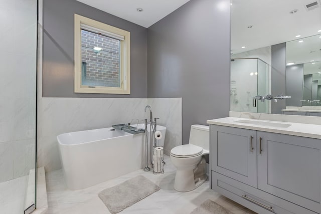 full bathroom featuring vanity, toilet, shower with separate bathtub, and tile walls