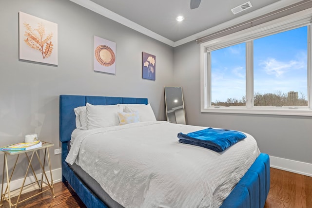 bedroom featuring crown molding, dark hardwood / wood-style floors, and ceiling fan