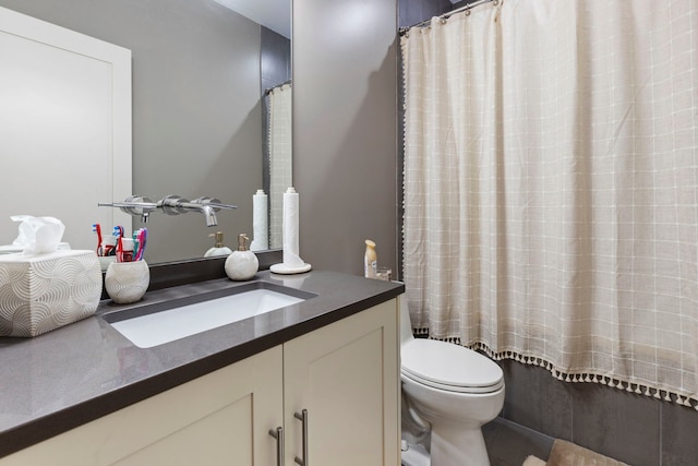 full bathroom with vanity, shower / bath combo, and toilet