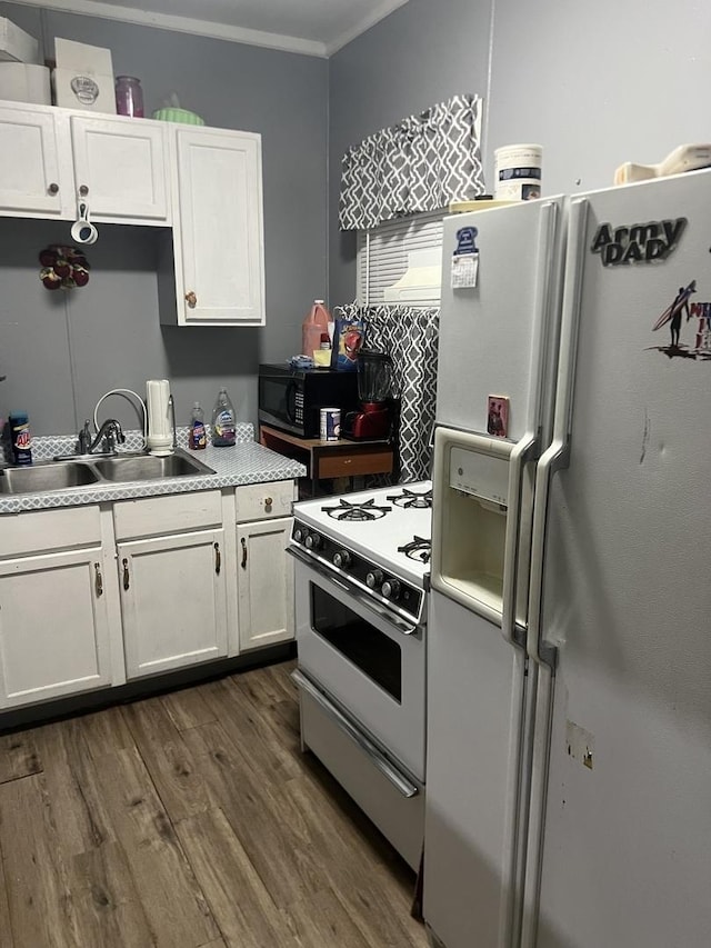 kitchen featuring white cabinetry, dark wood-type flooring, sink, and white appliances