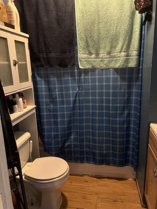 bathroom featuring hardwood / wood-style flooring and toilet