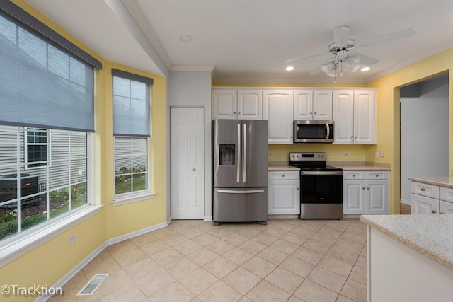 kitchen featuring white cabinetry, light tile patterned floors, ornamental molding, and appliances with stainless steel finishes