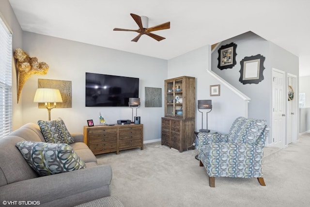 carpeted living room featuring ceiling fan