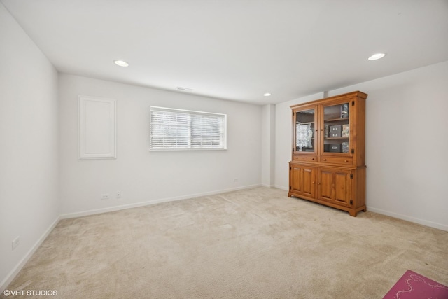 unfurnished room with light carpet