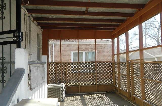 unfurnished sunroom featuring beam ceiling