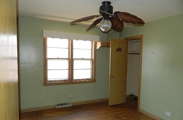 unfurnished room with hardwood / wood-style floors and ceiling fan