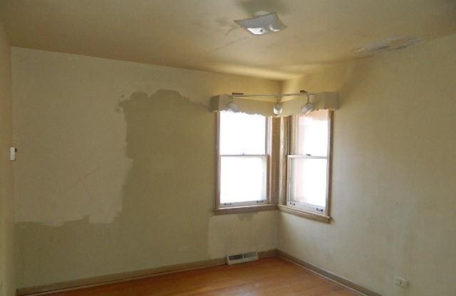 empty room with light hardwood / wood-style flooring