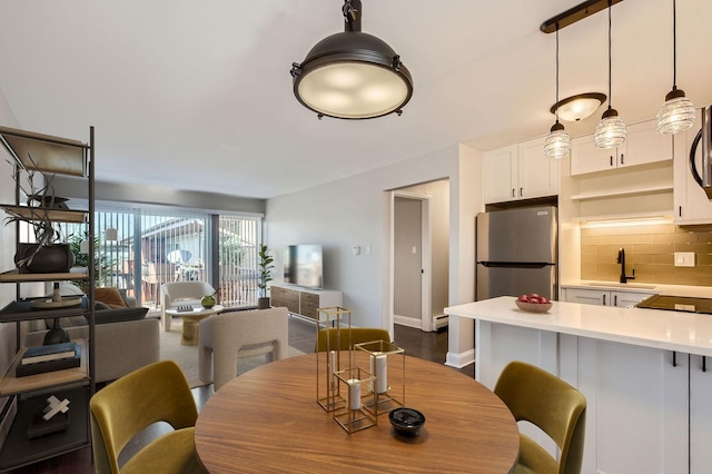 dining area featuring dark hardwood / wood-style floors and sink