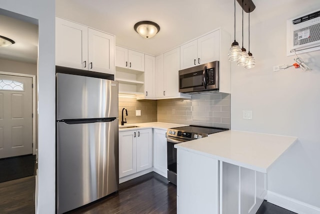 kitchen with sink, white cabinetry, decorative light fixtures, stainless steel appliances, and decorative backsplash