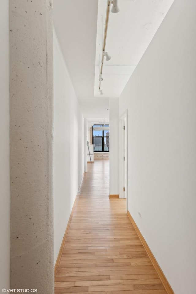 corridor with light wood-type flooring