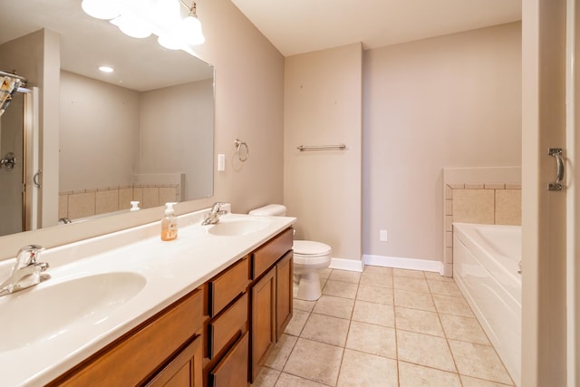 bathroom with tile patterned floors, toilet, a bath, and vanity