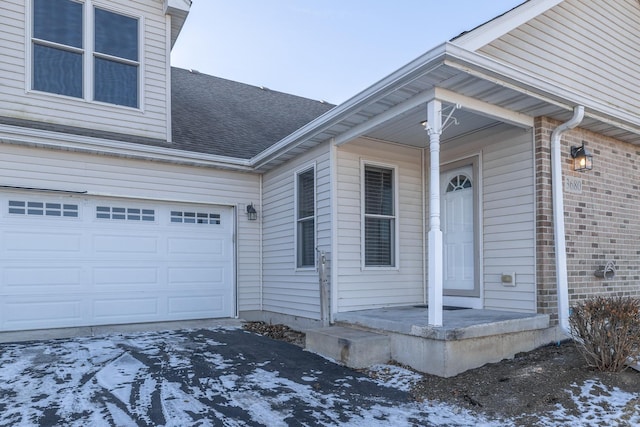 snow covered property entrance with a porch