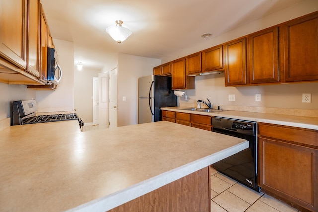 kitchen with stainless steel appliances, sink, light tile patterned floors, and kitchen peninsula