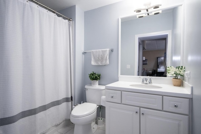 bathroom featuring vanity, tile patterned floors, and toilet