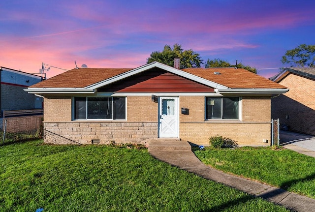 view of front of home with a lawn