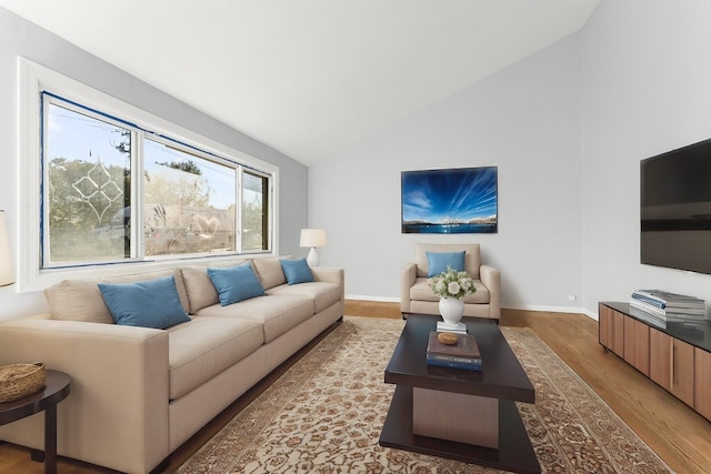 living room featuring vaulted ceiling and wood-type flooring