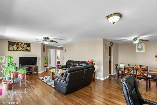 living room featuring hardwood / wood-style flooring and ceiling fan