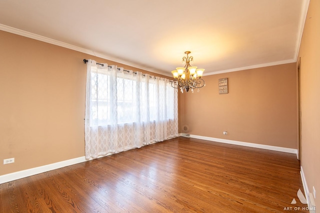 empty room featuring wood-type flooring, ornamental molding, and an inviting chandelier