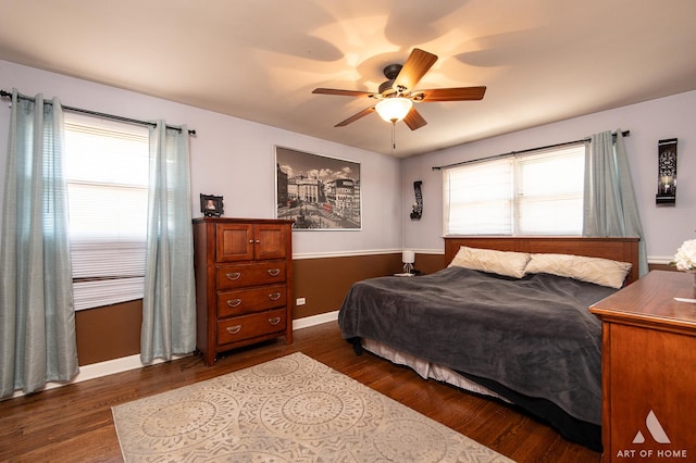 bedroom with ceiling fan and dark hardwood / wood-style floors