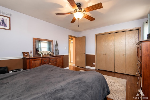 bedroom with dark wood-type flooring, a closet, and ceiling fan