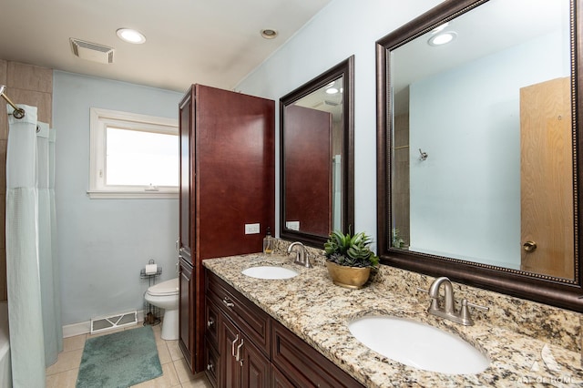 bathroom with tile patterned floors, vanity, and toilet