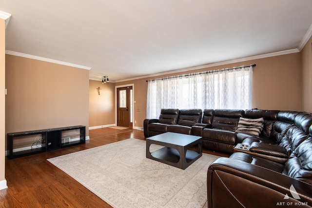 living room featuring dark hardwood / wood-style flooring, a wealth of natural light, and ornamental molding