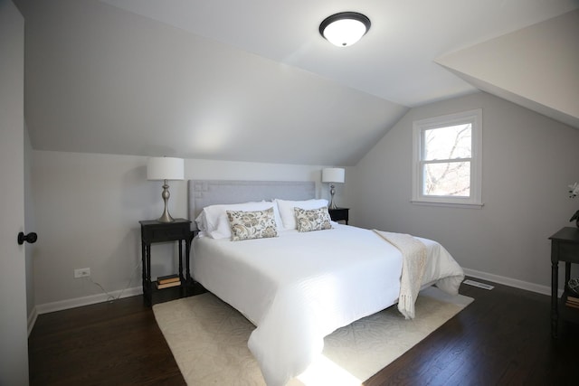 bedroom with lofted ceiling and dark wood-type flooring