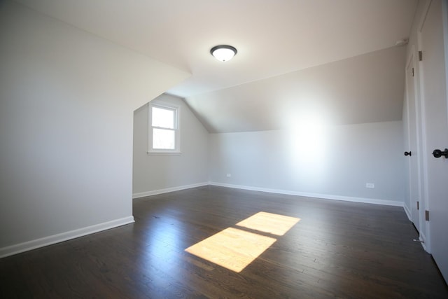 bonus room featuring dark wood-type flooring and lofted ceiling