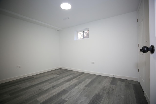 empty room with dark hardwood / wood-style flooring