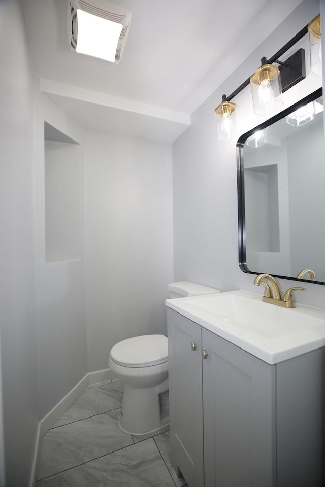 bathroom featuring vanity and toilet