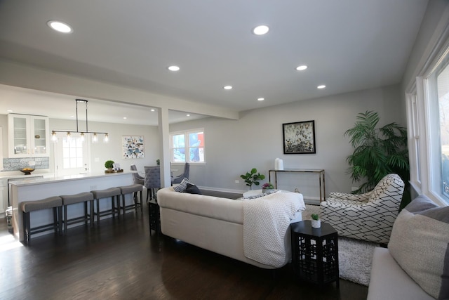 living room featuring dark hardwood / wood-style floors and a wealth of natural light