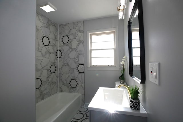 bathroom with vanity and tiled shower / bath combo