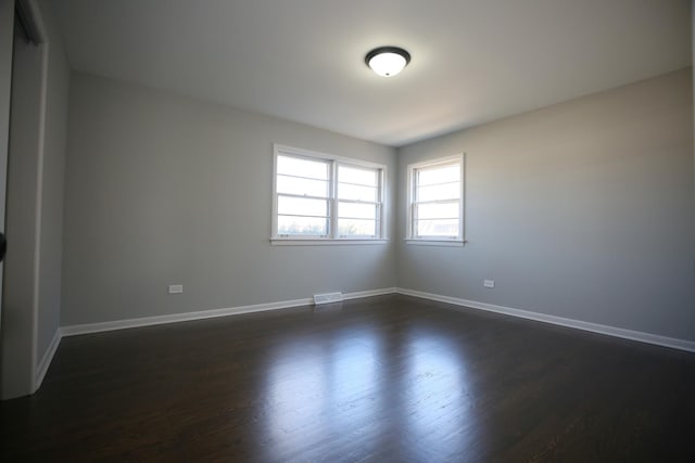 spare room featuring dark hardwood / wood-style floors